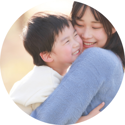 笑顔の男の子を抱っこしている母親